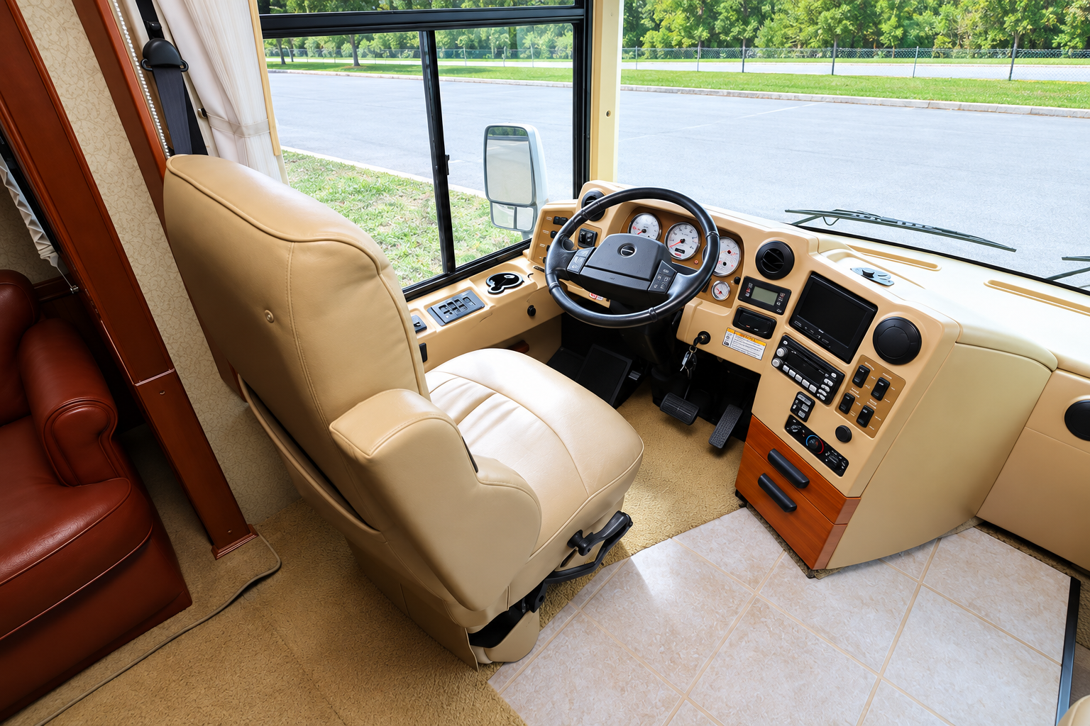 Captain's chair in the Vectra cockpit in daylight, tan leather with warm wood trim